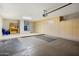 Spacious garage with ample storage cabinets, utility sink, and epoxy-coated flooring for easy maintenance at 15560 W Clear Canyon Dr, Surprise, AZ 85374