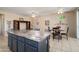 Large kitchen island with seating and granite countertops extending to dining area at 15560 W Clear Canyon Dr, Surprise, AZ 85374