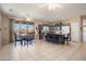 Open-concept kitchen with an island, granite countertops, modern appliances, and dining table at 15560 W Clear Canyon Dr, Surprise, AZ 85374