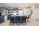 Spacious kitchen with granite countertops, stainless steel appliances, and breakfast bar seating at 15560 W Clear Canyon Dr, Surprise, AZ 85374