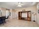 Open living space with tile flooring, a ceiling fan, and an entertainment center at 15560 W Clear Canyon Dr, Surprise, AZ 85374