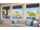 Enjoy expansive golf course views from this inviting living room with large windows and a comfortable sofa at 15560 W Clear Canyon Dr, Surprise, AZ 85374