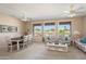 Bright and airy living room with dining area, comfortable seating, large windows, and view of golf course at 15560 W Clear Canyon Dr, Surprise, AZ 85374