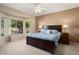 Serene main bedroom with large windows, plush carpet, and golf course views at 15560 W Clear Canyon Dr, Surprise, AZ 85374