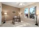 Cozy home office space with neutral colors, large windows bringing in natural light, and carpet flooring at 15560 W Clear Canyon Dr, Surprise, AZ 85374