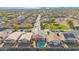 A high aerial view showing neat residential streets and homes near park space and a mountain view in the distance at 1563 S 227Th Ave, Buckeye, AZ 85326