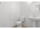 Simple powder bathroom features white fixtures and tile flooring at 1563 S 227Th Ave, Buckeye, AZ 85326