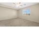 Carpeted bedroom with a ceiling fan and a window at 1563 S 227Th Ave, Buckeye, AZ 85326