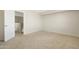 Carpeted bedroom with a ceiling fan and open door at 1563 S 227Th Ave, Buckeye, AZ 85326