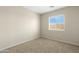Bedroom featuring carpet flooring, neutral walls, and a window with natural lighting, creating a bright space at 1563 S 227Th Ave, Buckeye, AZ 85326