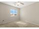 Bedroom offering neutral walls and carpet flooring with natural light from a window, creating a cozy space at 1563 S 227Th Ave, Buckeye, AZ 85326