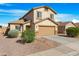 Stylish two-story home with desert landscaping, a two-car garage, and a well-maintained facade at 1563 S 227Th Ave, Buckeye, AZ 85326