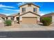 Inviting two-story home showcasing a neutral facade, a cozy front porch, and a convenient two-car garage at 1563 S 227Th Ave, Buckeye, AZ 85326