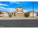 Charming two-story home featuring a neutral-colored exterior, well-kept landscaping, and a two-car garage at 1563 S 227Th Ave, Buckeye, AZ 85326