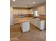 Well-lit kitchen with white cabinets, wood countertops, and a functional island at 1563 S 227Th Ave, Buckeye, AZ 85326