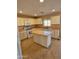 Bright kitchen with white cabinetry, butcher block countertops, and a central island at 1563 S 227Th Ave, Buckeye, AZ 85326