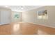Open living room with wood floors, large windows, and plenty of natural light creating a welcoming space at 1563 S 227Th Ave, Buckeye, AZ 85326