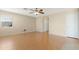 Open living room with wood laminate flooring and a ceiling fan at 1563 S 227Th Ave, Buckeye, AZ 85326