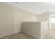 Cozy carpeted loft space with neutral walls and natural light perfect for relaxing or working at 1563 S 227Th Ave, Buckeye, AZ 85326