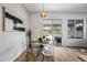 Bright dining area with a glass table and clear chairs, flooded with natural light at 15815 W Hilton Ave, Goodyear, AZ 85338