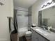 Updated bathroom featuring a tub with tiled surround, vanity, and a modern mirror at 1701 E Colter St # 138, Phoenix, AZ 85016