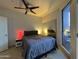 Comfortable bedroom with a ceiling fan, closet, and access to the outdoor patio at 1701 E Colter St # 138, Phoenix, AZ 85016