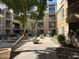 Beautiful courtyard featuring mature landscaping and seating areas, creating a tranquil community space at 1701 E Colter St # 138, Phoenix, AZ 85016
