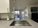 Modern kitchen with a view of the patio through sliding glass doors at 1701 E Colter St # 138, Phoenix, AZ 85016