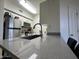 Modern kitchen features stainless steel appliances, white cabinetry, and sleek countertops at 1701 E Colter St # 138, Phoenix, AZ 85016