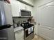 Modern kitchen featuring stainless steel appliances and white cabinetry at 1701 E Colter St # 138, Phoenix, AZ 85016