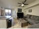 Open-concept living room with tile floors, ceiling fan, and sliding door to the patio at 1701 E Colter St # 138, Phoenix, AZ 85016
