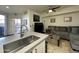 Modern kitchen and comfortable living space open to each other, stainless steel appliances, and neutral decor at 1701 E Colter St # 138, Phoenix, AZ 85016