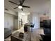 Comfortable living area open to the kitchen, featuring a ceiling fan and neutral decor at 1701 E Colter St # 138, Phoenix, AZ 85016