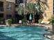 Relaxing poolside area featuring lounge chairs, patio furniture, and lush trees for shade at 1701 E Colter St # 138, Phoenix, AZ 85016