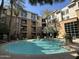 Inviting pool area surrounded by lush landscaping, palm trees, and lounge chairs for relaxing at 1701 E Colter St # 138, Phoenix, AZ 85016