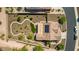 Overhead shot showcasing desert landscaped backyard with winding stone walkways, covered patio and solar panels at 1775 N 164Th Dr, Goodyear, AZ 85395