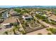 Aerial view of a home with a landscaped backyard featuring desert landscaping, walkways, and a covered patio at 1775 N 164Th Dr, Goodyear, AZ 85395
