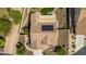 Aerial view of a home showcasing its tile roof with solar panels, desert landscaping, and a synthetic grass area at 1775 N 164Th Dr, Goodyear, AZ 85395