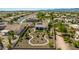 Aerial view of a home with a landscaped backyard featuring desert landscaping, walkways, and a covered patio at 1775 N 164Th Dr, Goodyear, AZ 85395