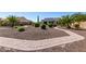 Backyard displaying desert landscaping, a stone pathway, and view of the home at 1775 N 164Th Dr, Goodyear, AZ 85395