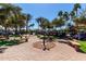 Scenic view of the community with golf carts, benches and beautiful palm trees at 1775 N 164Th Dr, Goodyear, AZ 85395
