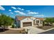 Exterior featuring a tile roof, desert landscaping, and a two-car garage at 1775 N 164Th Dr, Goodyear, AZ 85395