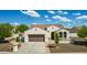 Charming single-story home featuring a well-manicured front yard, a two-car garage, and a cozy front porch at 1775 N 164Th Dr, Goodyear, AZ 85395