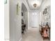 Inviting hallway with neutral walls, tiled flooring, and decorative accents, leading to the main living areas at 1775 N 164Th Dr, Goodyear, AZ 85395