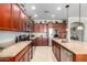 Kitchen featuring stainless steel appliances, granite countertops and abundant cherry cabinets at 1775 N 164Th Dr, Goodyear, AZ 85395