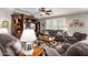 Comfortable living room featuring plush seating, a ceiling fan, and a decorative entertainment center at 1775 N 164Th Dr, Goodyear, AZ 85395
