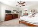Spacious main bedroom with carpet, a large television, and matching dressers at 1775 N 164Th Dr, Goodyear, AZ 85395
