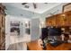 Office space with a wooden desk, built-in shelves, and views into kitchen and laundry room at 1775 N 164Th Dr, Goodyear, AZ 85395