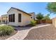 A side yard featuring desert landscaping, a stone pathway, and gate at 1775 N 164Th Dr, Goodyear, AZ 85395