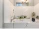 Walk in tub with decorative accents and a view from the window at 1775 N 164Th Dr, Goodyear, AZ 85395